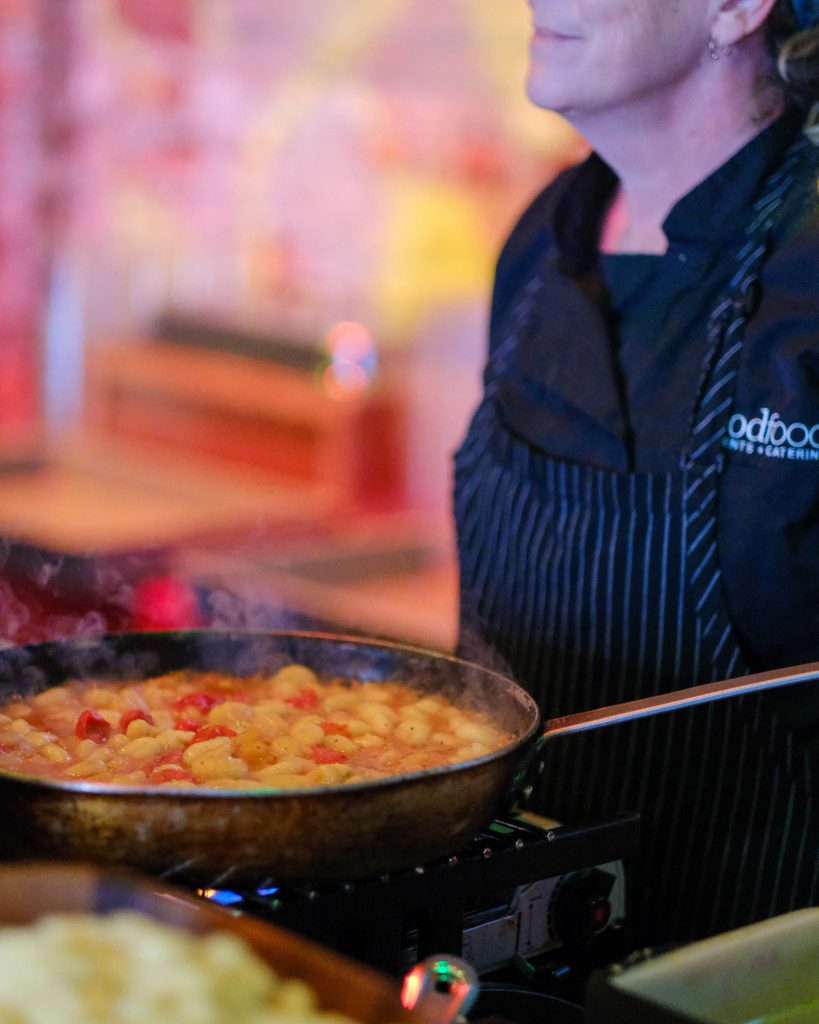 Good Food chef preparing pasta at a large event at Armature Works