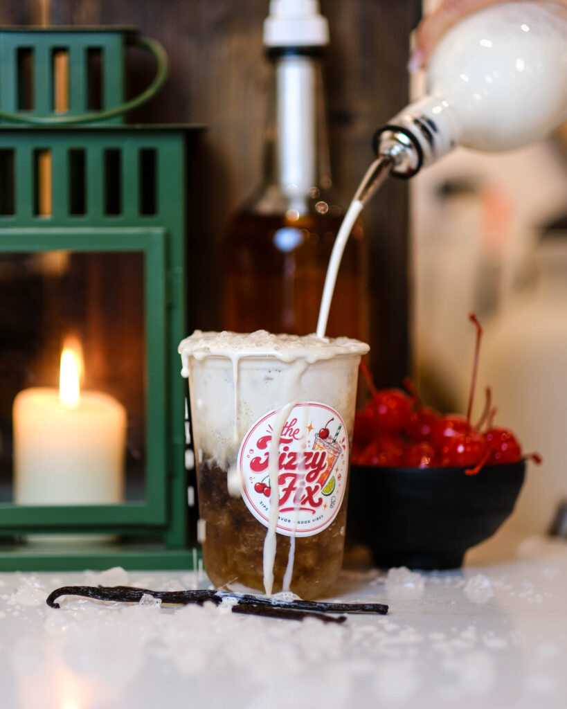 Fizzy Fix Dirty Soda with cream overflowing